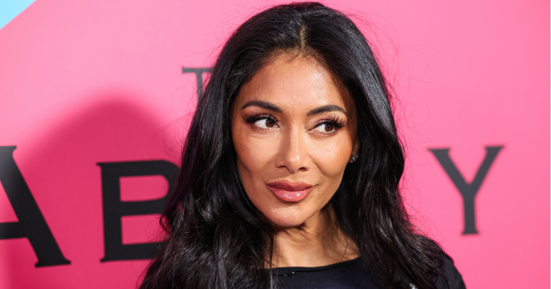 Nicole Scherzinger poses in a black t-shirt