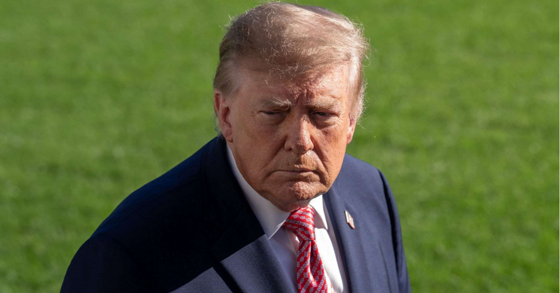 Donald Trump looking stern in a suit