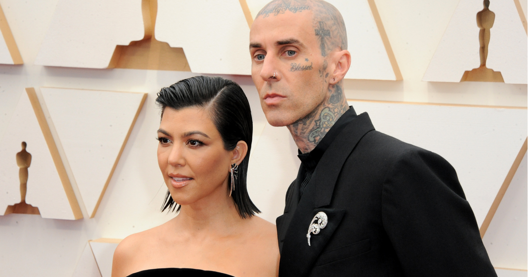 Kourtney Kardashian and Travis Barker pose on the red carpet