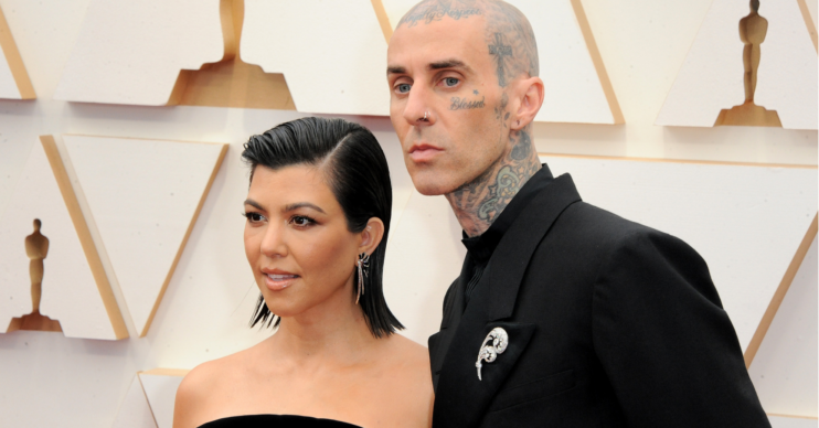 Kourtney Kardashian and Travis Barker pose on the red carpet