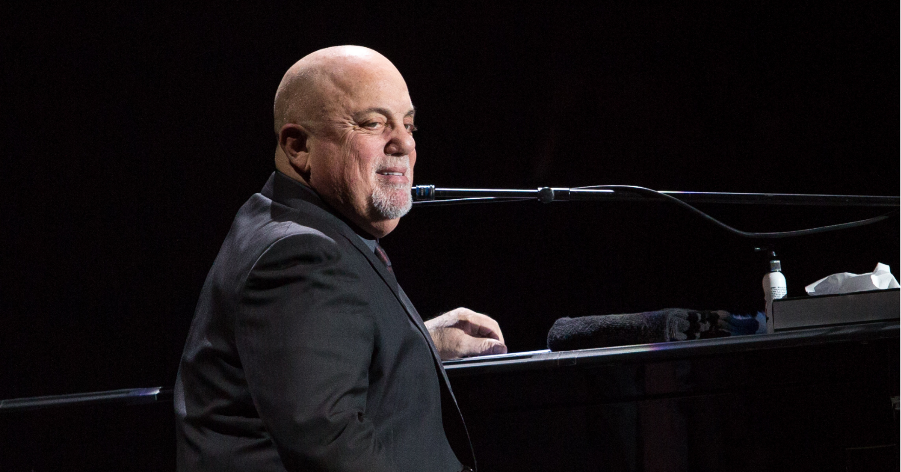 Billy Joel sits at the piano