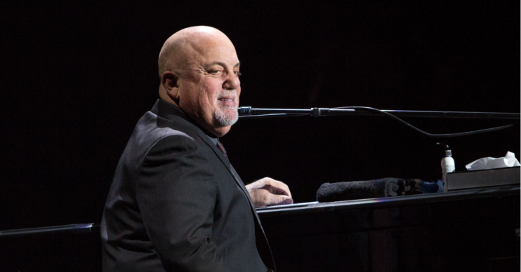 Billy Joel sits at the piano