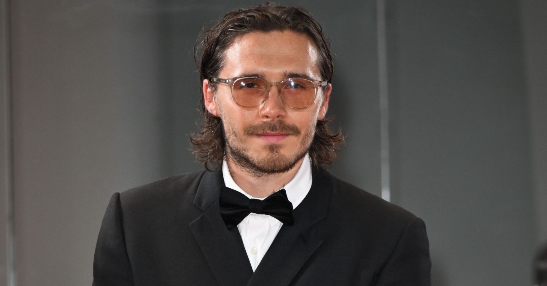 Brooklyn Beckham at an event wearing suit