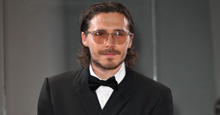 Brooklyn Beckham at an event wearing suit