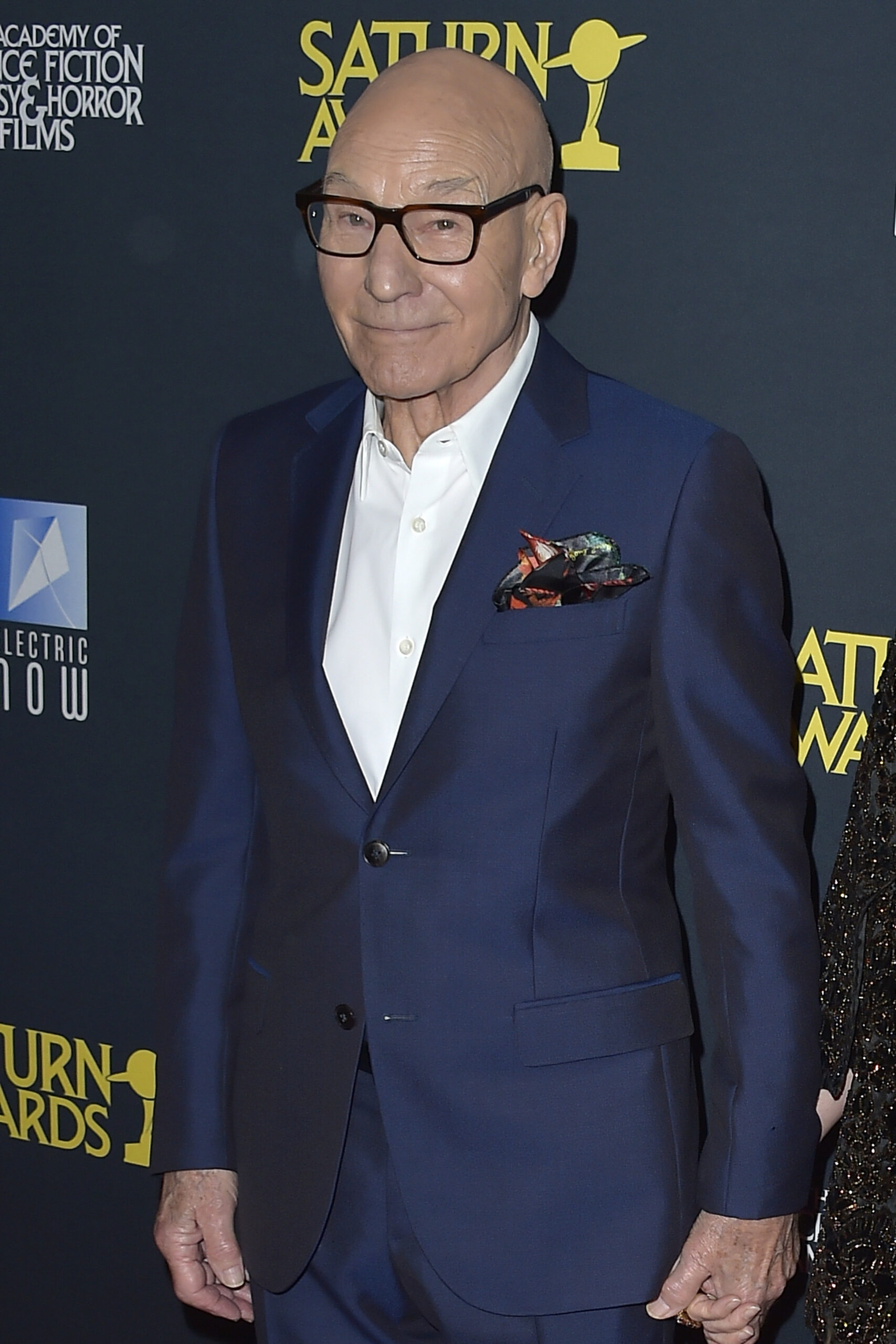 Patrick Stewart wears a blue suit