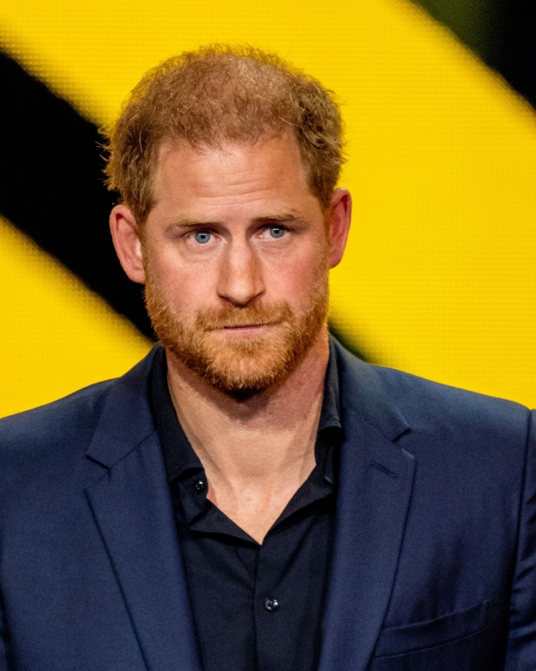 Prince Harry on a yellow and black background 