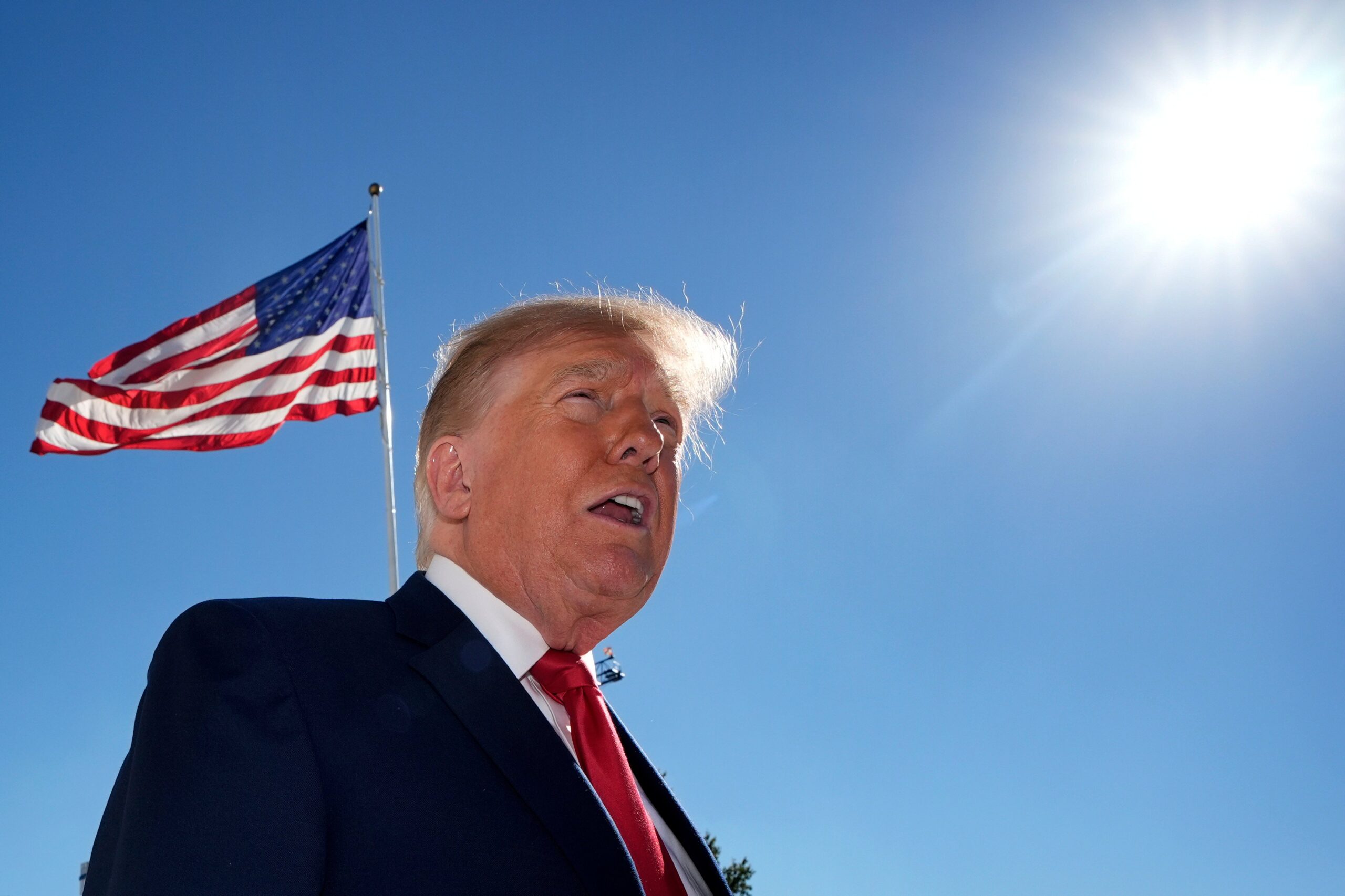 Donald Trump next to the American flag