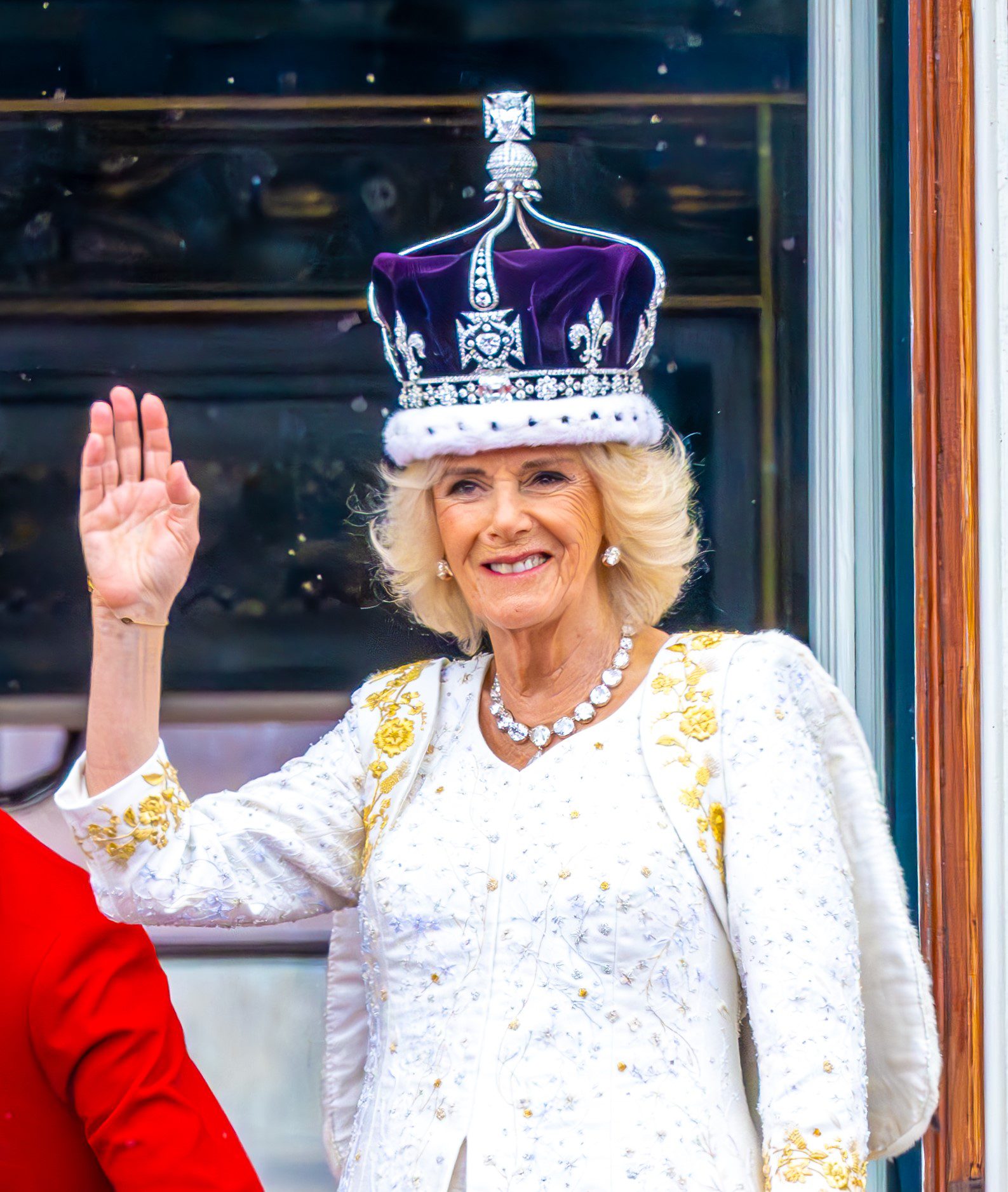 Queen Consort Camilla in blue hat smiling