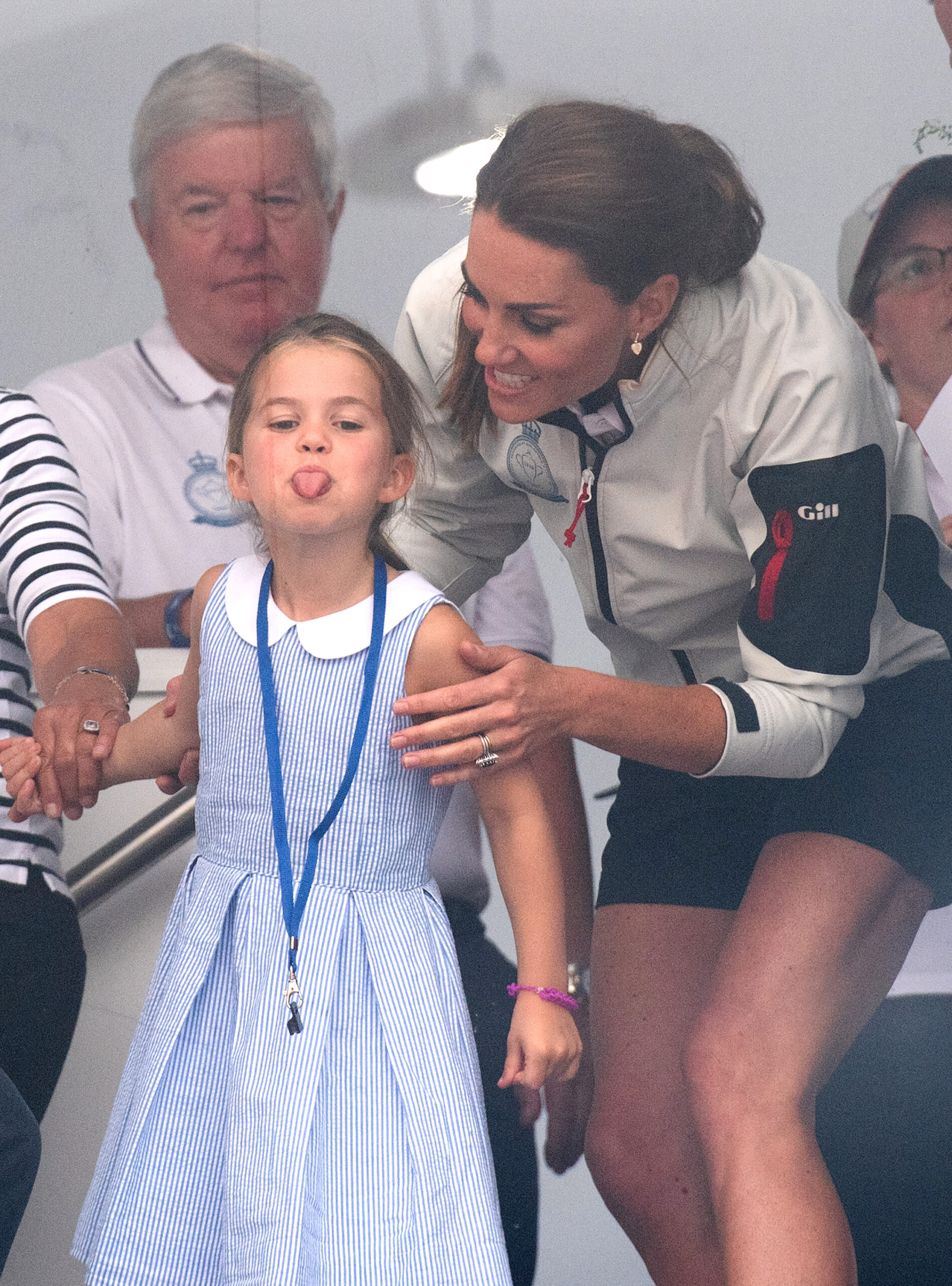 Princess Charlotte sticking her tongue out and Kate Middleton smiling