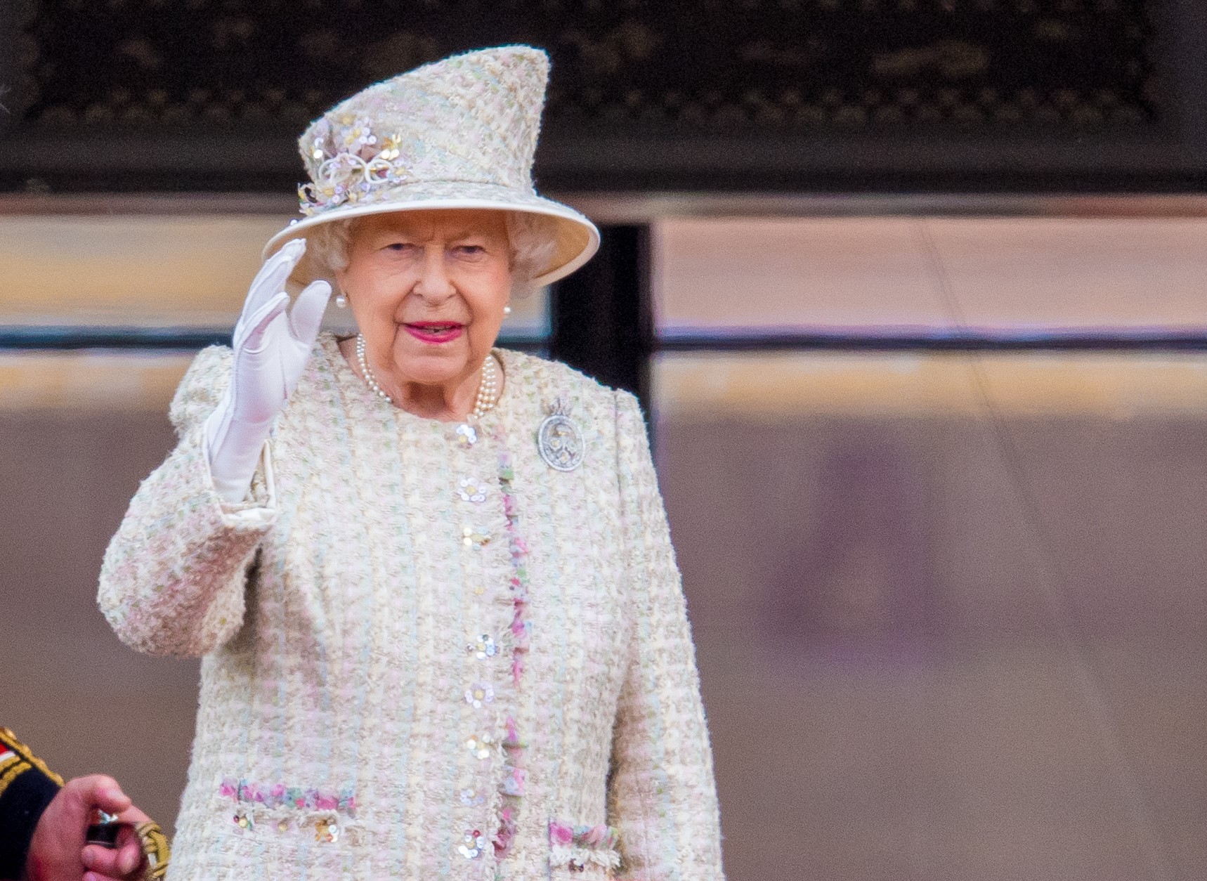 The Queen waving and smiling during royal engagement