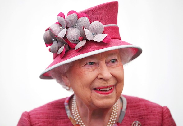 The Queen smiles in pink outfit during engagement