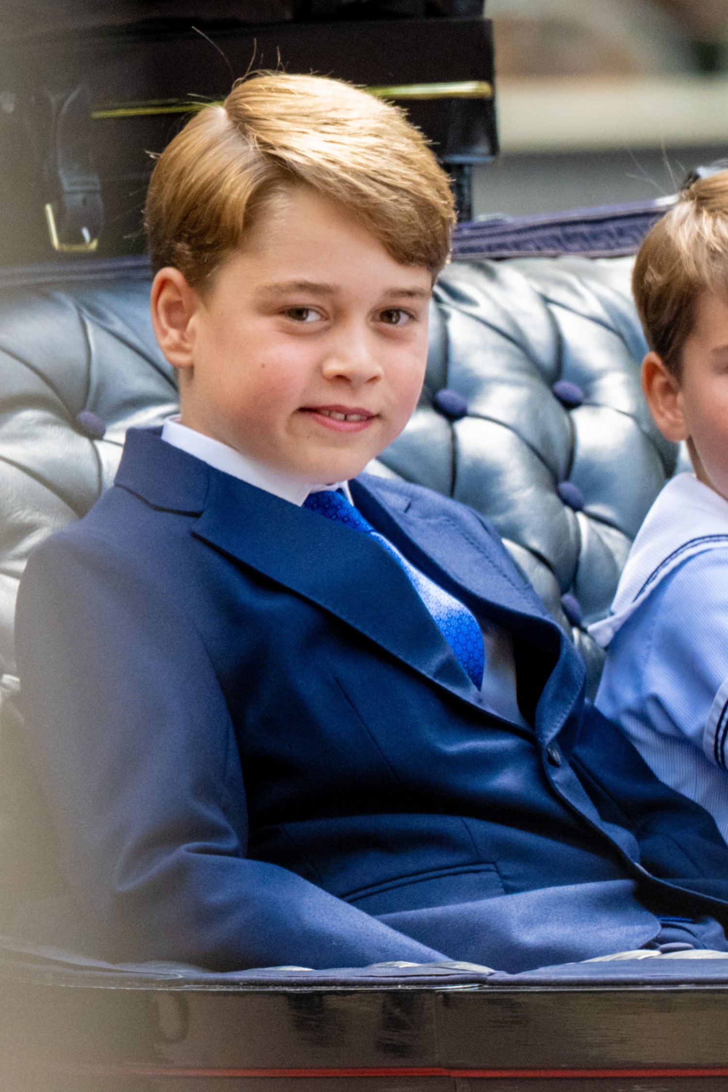 Prince George smiling in a carriage 