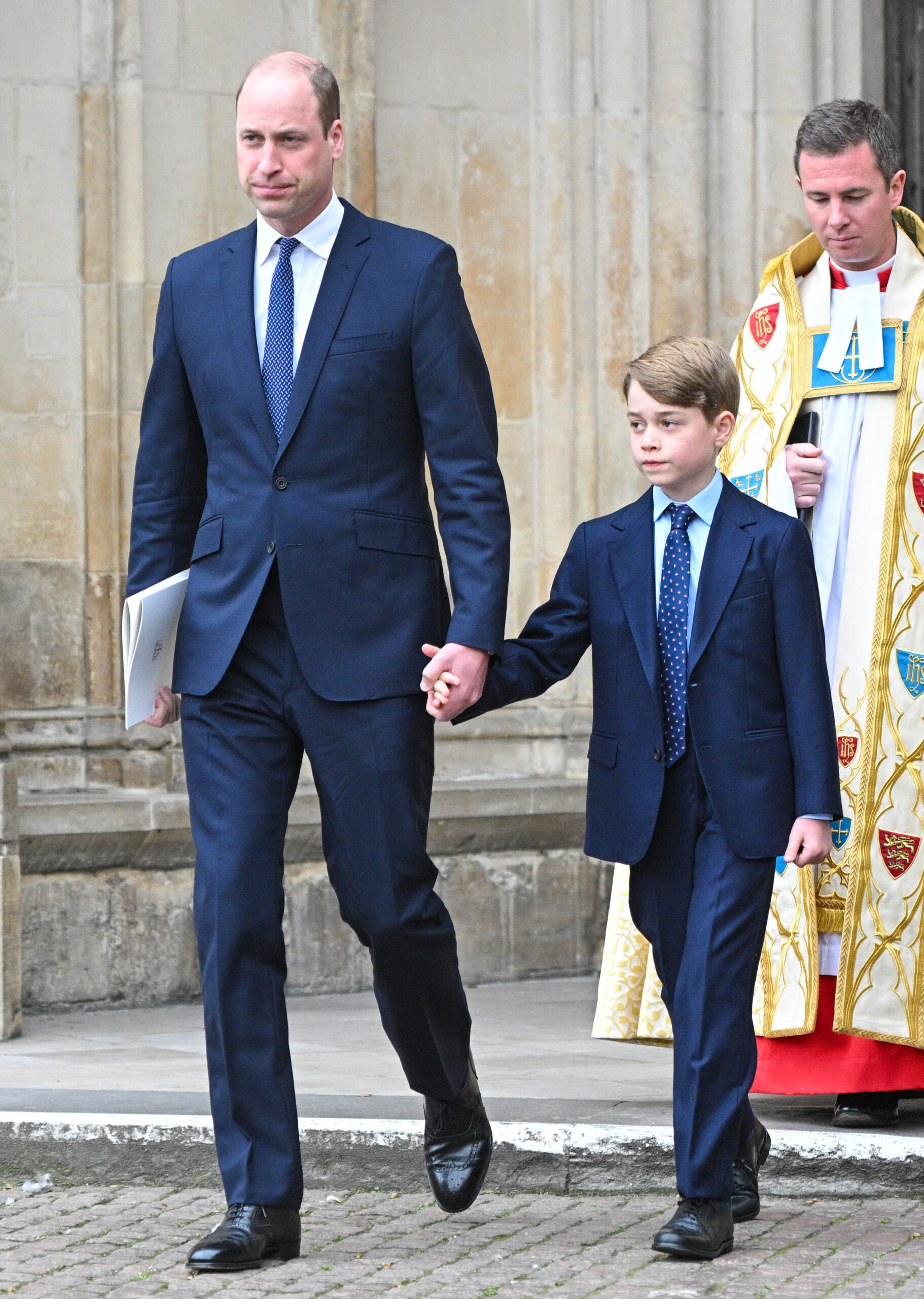 Prince William holding hands with Prince George